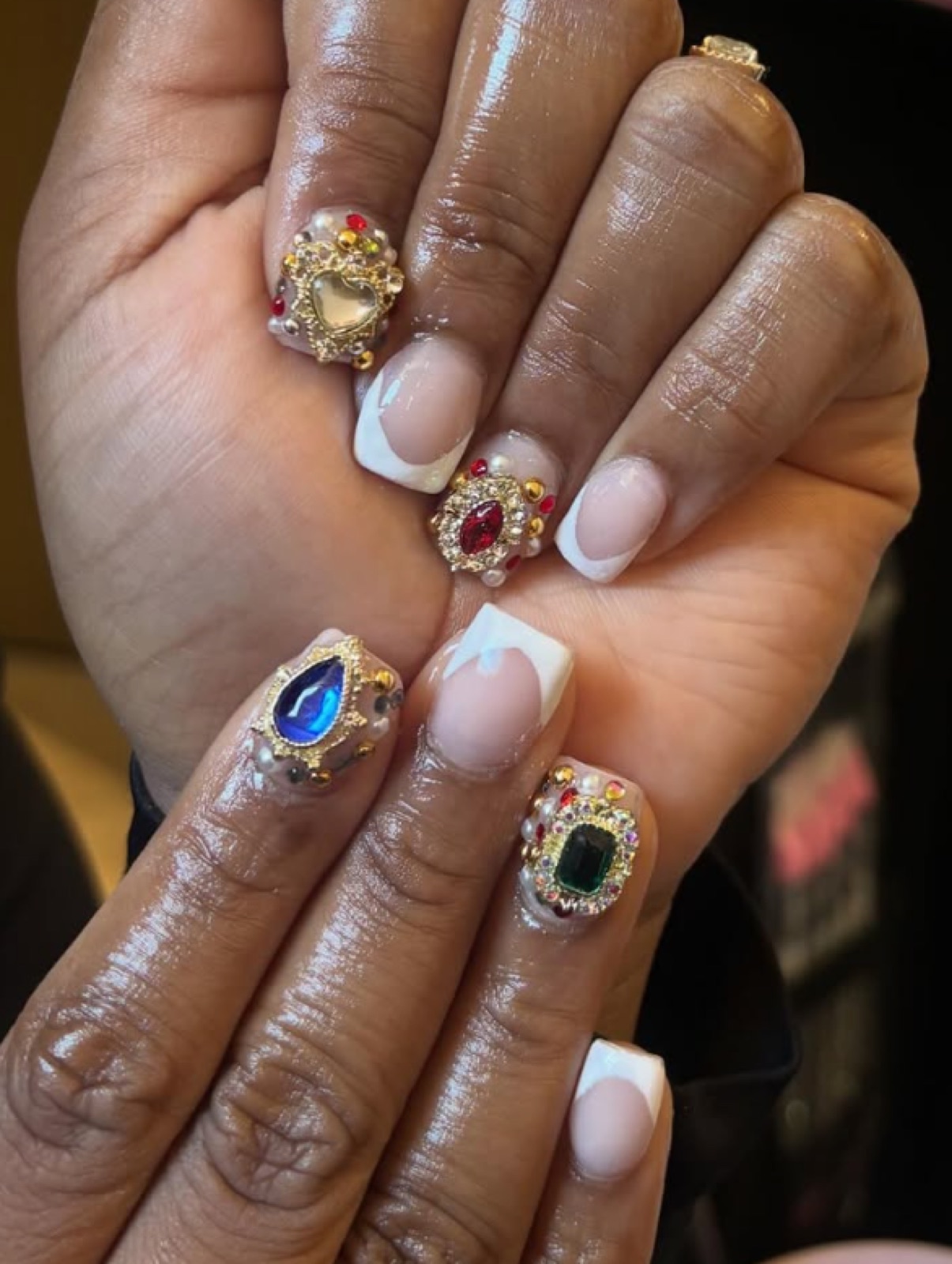 Short square French set with gold-framed jewel accents in ruby, sapphire and emerald, with pearl and gold bead detailing.